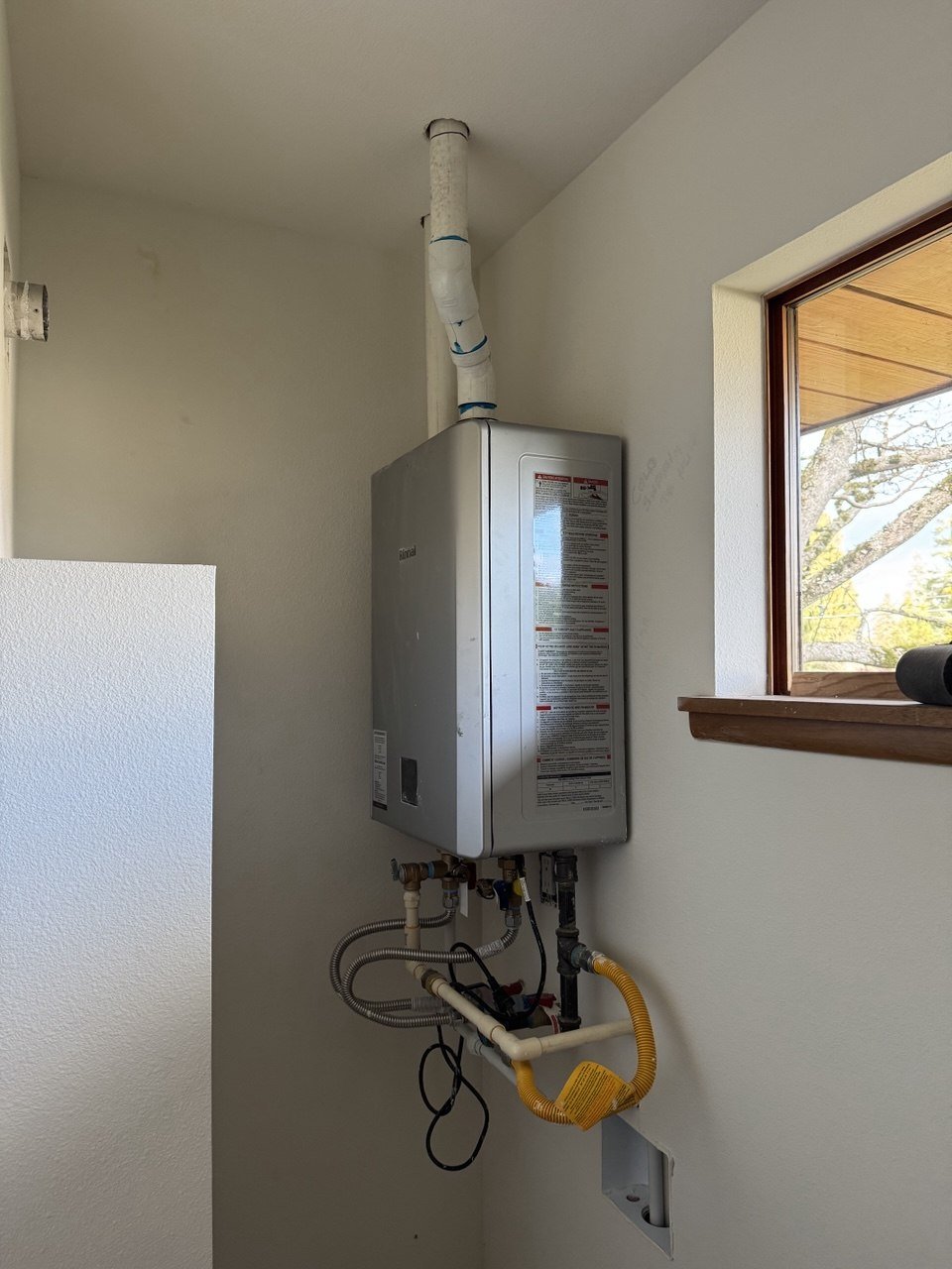 Tankless water heater installation with new gas and water connections